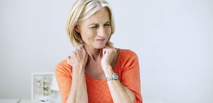 Mature woman suffering from neck and shoulder pain before visiting Sandpoint chiropractor