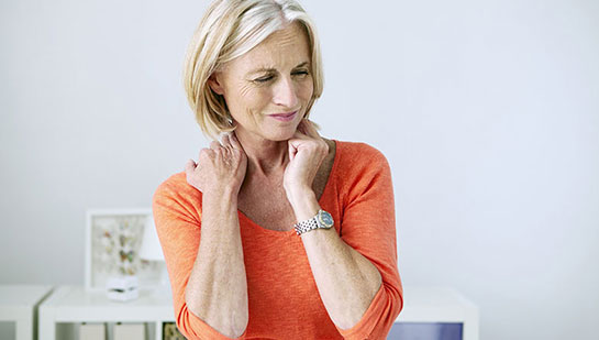 Mature woman suffering from neck and shoulder pain before visiting Sandpoint chiropractor