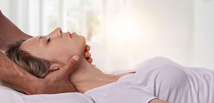 Woman receiving neck adjustment from Sandpoint chiropractor